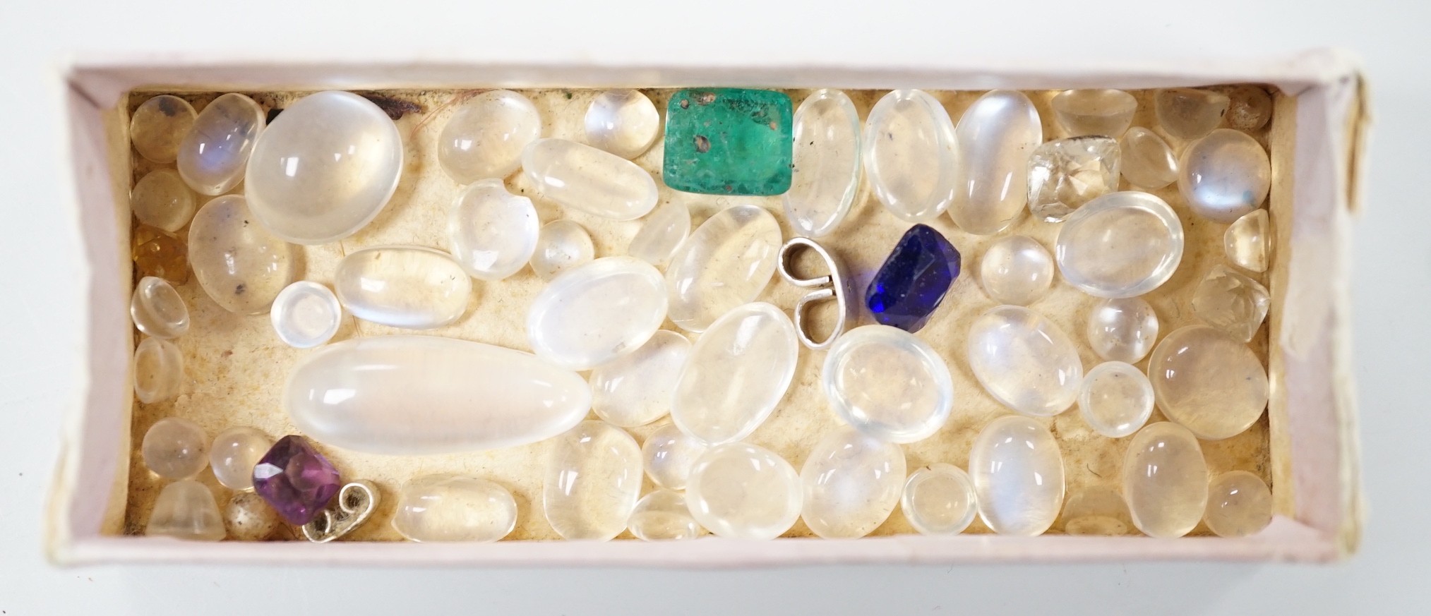 A small quantity of unmounted cabochon moonstones of varying sizes and four other unmounted coloured stones including green paste.